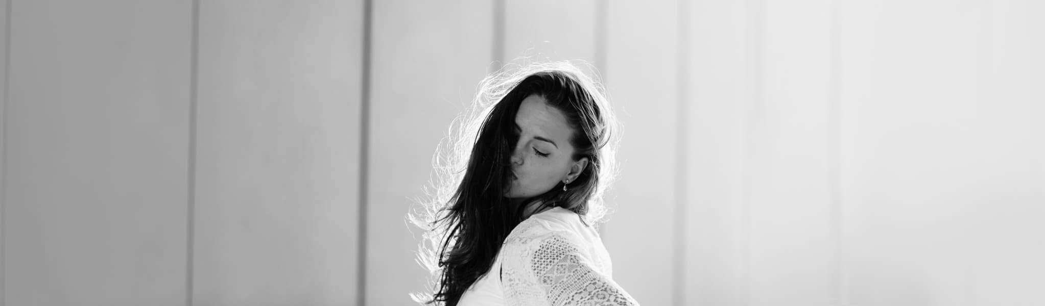 Faded greyscale modelling shot of Emily Coatman for the footer