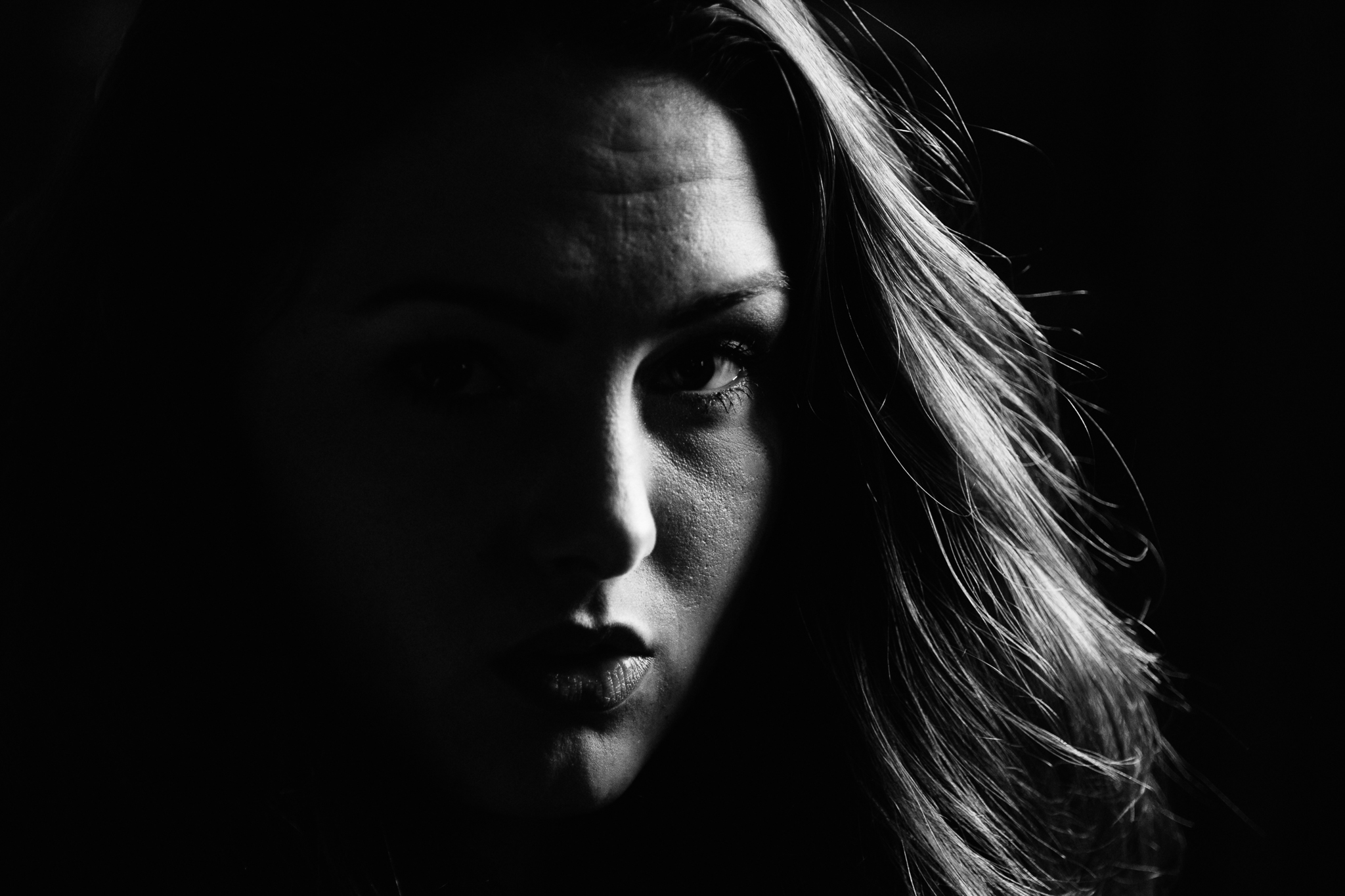 Black and white dark face portrait of Emily Coatman